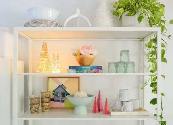 Étagères de cuisine en métal blanc avec des arbres de Noël éclairés et colorés