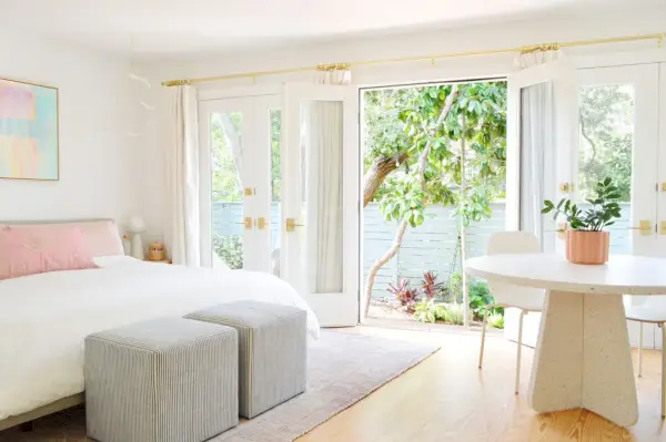 Quarto com cama king size e portas francesas abertas para o jardim