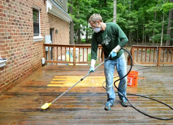 John schrubbt das Deck mit einer am Schlauch befestigten Bürste