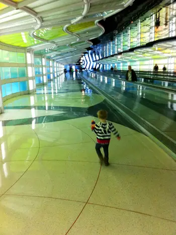 volant amb un nen jugant a l'aeroport amb llums fresques